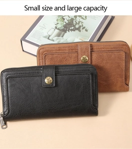 Macro view of vintage leather texture and buckle detail on long zipper wallets