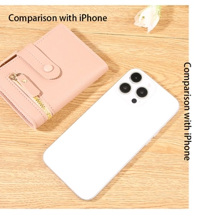 Pink lychee texture leather small wallet size comparison with a white iPhone on wood