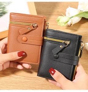 Detailed view of leather texture and zipper compartments on black and brown mini wallets