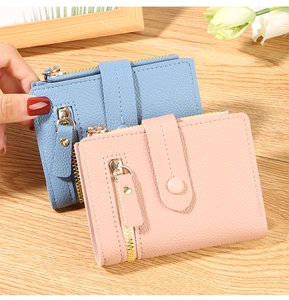 Litchi pattern leather wallet detail with metal zipper and snap button in blue and pink