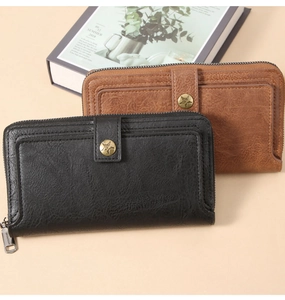 Detail of vintage long wallets with star emblem and textured faux leather finish