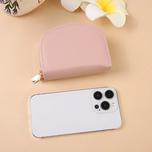 Pink pebbled leather accordion card holder with gold zipper and compact semi-circle design
