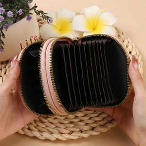 Pink fabric accordion card wallet with dual gold zippers and multiple interior slots