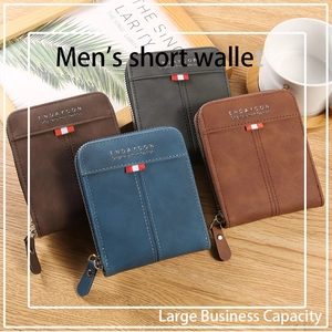 Men's bifold zip wallets in four colors displayed on a wooden surface with red stripes