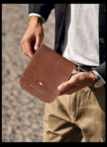 Close-up of brown vintage leather men's wallet with double stitching and metal zipper