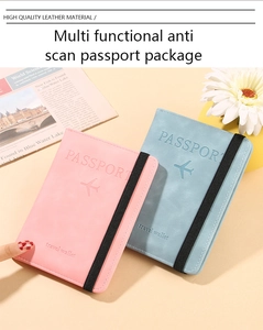Detail of travel passport wallets in pink and blue with elastic band and embossed logo