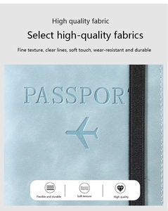 Close-up of light blue PU leather passport cover showing soft texture and elastic strap