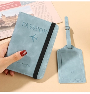 Detail of light blue PU leather passport holder and luggage tag set with elastic band