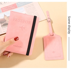 Pink PU leather travel set detail featuring passport cover with strap and matching luggage tag