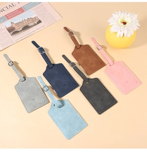 Flat lay of six colorful PU leather luggage tags with adjustable straps and airplane logo