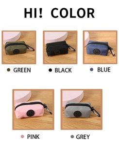 Detail view of nylon dog poop bag holders in green, black, blue, pink, and grey colors