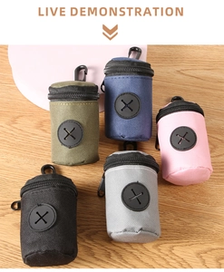Portable pet waste bag dispensers in five colors with carabiners on wooden background