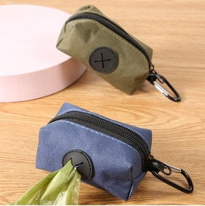 Detail view of nylon pet waste bag dispensers in army green and navy blue with metal clips