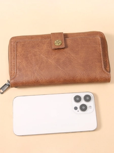 Long vintage brown PU leather wallet with buckle and zipper beside a smartphone