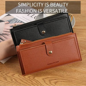 Detail of long wallet showing premium pebble leather texture and metal zipper closure