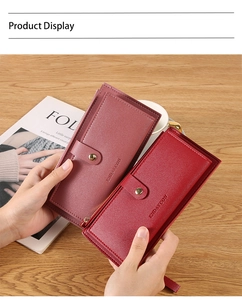 Detail view of pink and dark red leather long wallets with lychee texture and metal zip