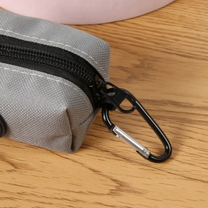 Gray Oxford fabric dog waste bag dispenser with black zipper and metal carabiner