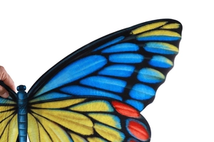 Detail of vibrant blue and yellow butterfly wings costume with realistic texture