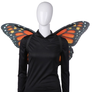 Detail of adult monarch butterfly wings with orange patterns and black elastic straps
