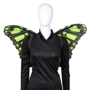 Detail of green and black butterfly wings with elastic straps on a mannequin back