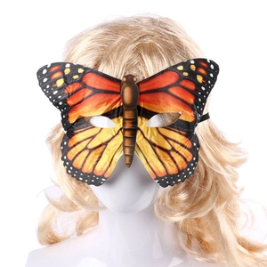 Detail of orange monarch butterfly wing party mask with realistic fabric texture