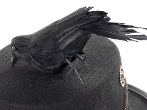Close-up of gothic steampunk top hat featuring faux crow feathers and metal gear chains