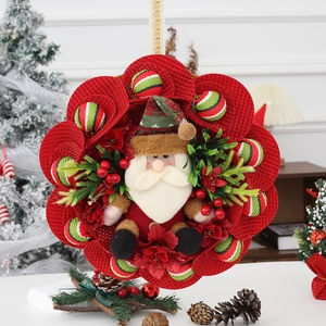 Festive Christmas wreath featuring a 3D Santa plush with red mesh and berry accents