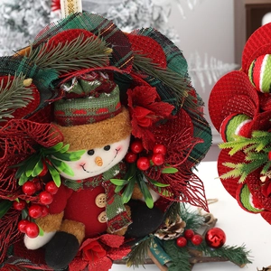 Christmas snowman wreath with plaid patterns, pine needles and festive red berries