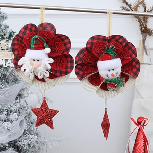 Detail of Christmas flower ornaments with Santa and Snowman plush heads in red plaid fabric