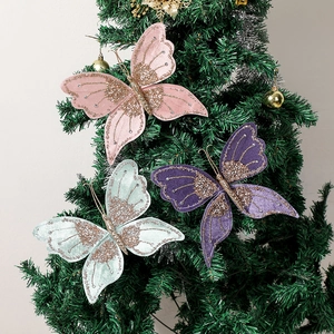 Detailed view of pink and purple sequined butterfly ornaments on a green Christmas tree