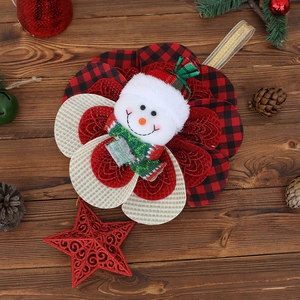 Detail of Christmas snowman ornament with red plaid hat and glitter star on wood base