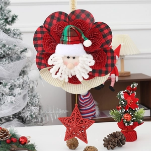 Detail of Christmas Santa ornament with red plaid hat and sparkly star wall hanging