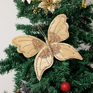 Detailed view of a gold glitter butterfly ornament with rhinestones on a Christmas tree