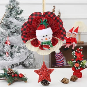 Detail of Christmas snowman hanging ornament with red plaid base and glittery star pendant
