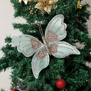 Macro detail of mint green velvet butterfly ornament with glitter on Christmas tree
