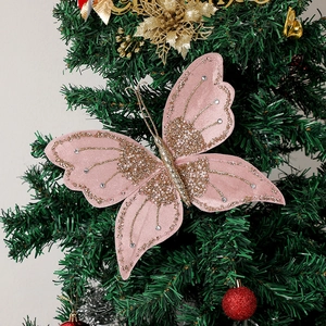 Detail showing pink butterfly ornament with glitter and rhinestones on a Christmas tree