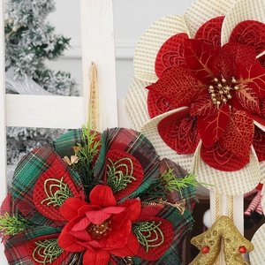Detailed view of red plaid and cream striped fabric poinsettias for Christmas decor