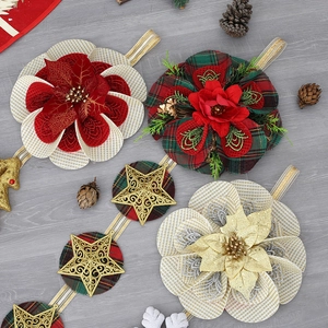 Detail of Christmas fabric flowers and gold glitter stars on grey wood background