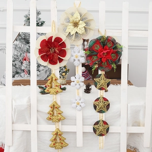 Detailed view of Christmas hanging ornaments featuring ribbon flowers and festive pendants