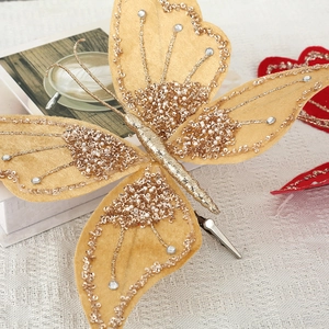 Sparkling yellow butterfly Christmas ornament with gold sequins and pearls on tree clip
