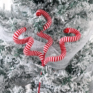 Christmas tree pick with red and white striped swirl branches and festive bells