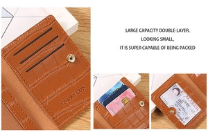 Detail of brown crocodile pattern wallet featuring card slots and license window with snap