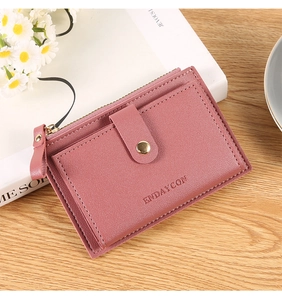Detail of pink leather wallet featuring multi-card slots and secure zipper pocket
