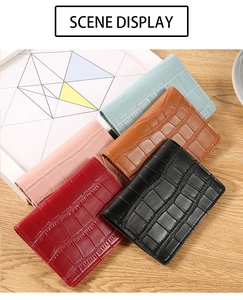 Close-up of crocodile embossed PU leather texture on multi-color wallet variety