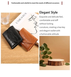 Detail of crocodile pattern faux leather wallets in black and caramel colors
