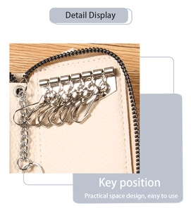 Detail of cream PU leather key case showing 6 metal hooks and practical internal storage