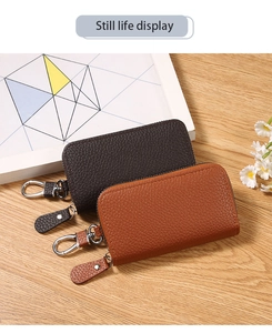Macro detail of textured PU leather key pouches with smooth zippers and metal swivel hooks