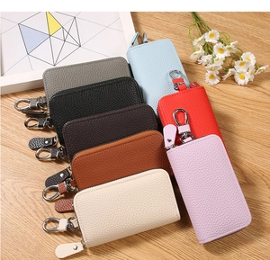 Detailed view of textured PU leather key pouches in eight diverse colors with zippers