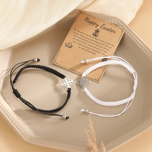 Handmade woven cross bracelet set in black and white with adjustable silver charms for couples