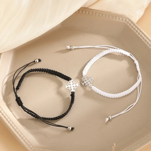 Handmade woven couple bracelets with silver Jerusalem cross charms in black and white